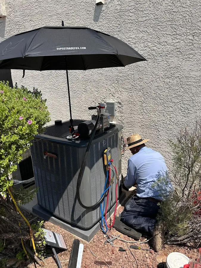 HVAC technician performing outdoor AC maintenance in Leesylvania